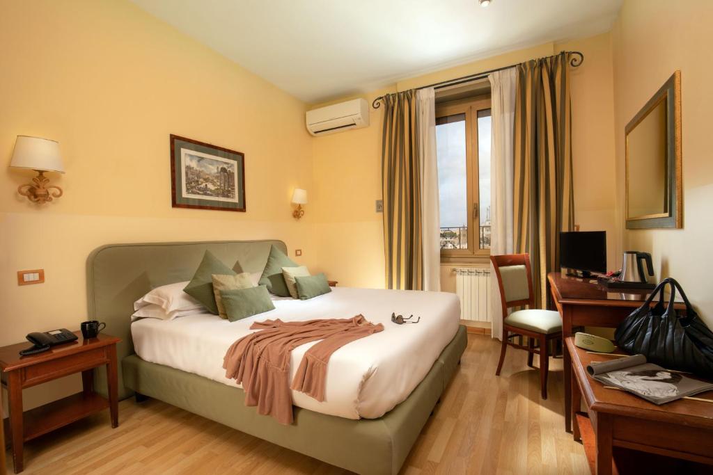 Postel nebo postele na pokoji v ubytování Hotel Colosseum