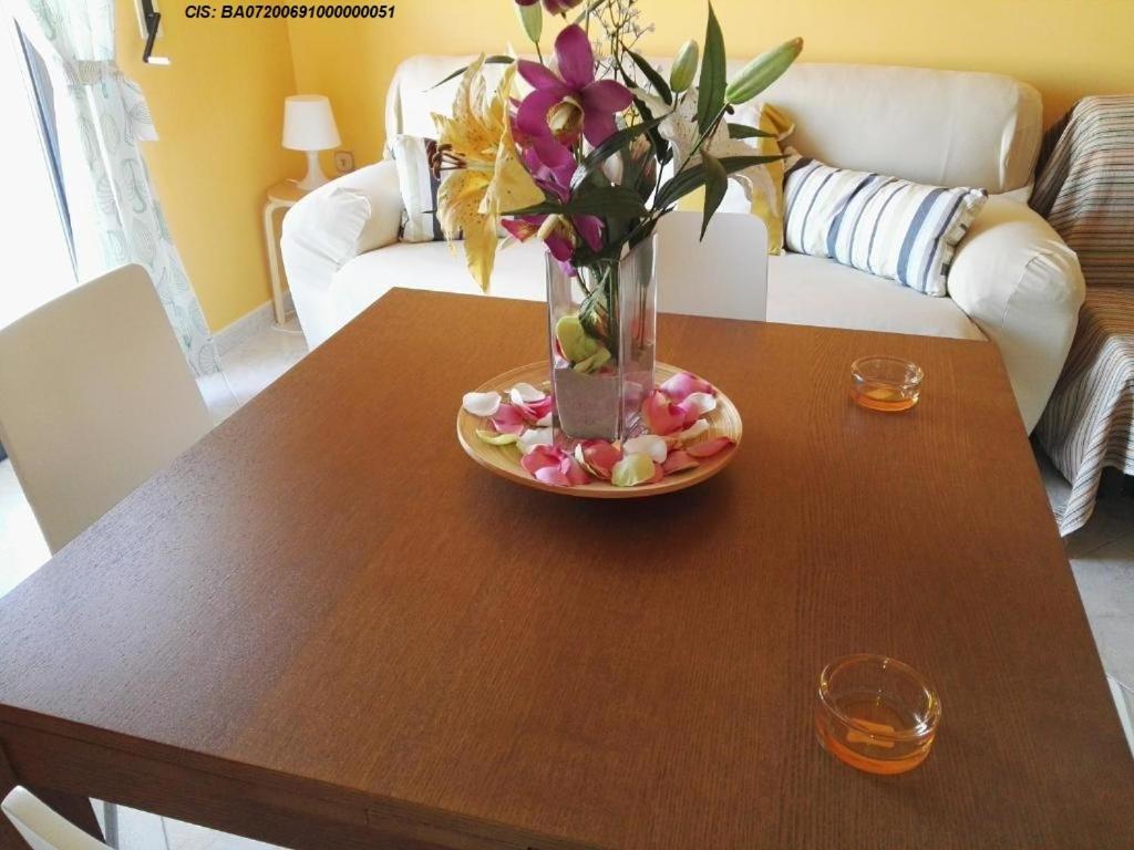 a table with a vase of flowers on top of it at La Bomboniera in Bari