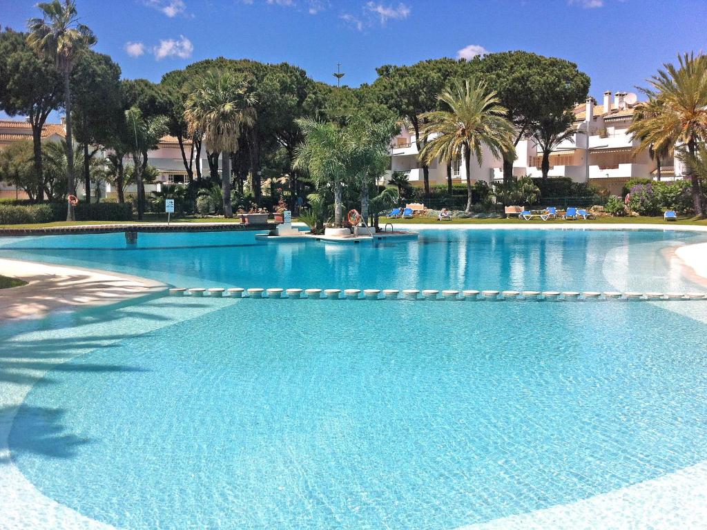 a large swimming pool with blue water in a resort at Apartment El Presidente by Interhome in Estepona