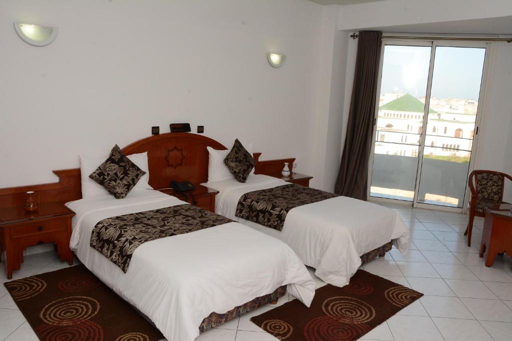 Postel nebo postele na pokoji v ubytování Hotel Bouregreg
