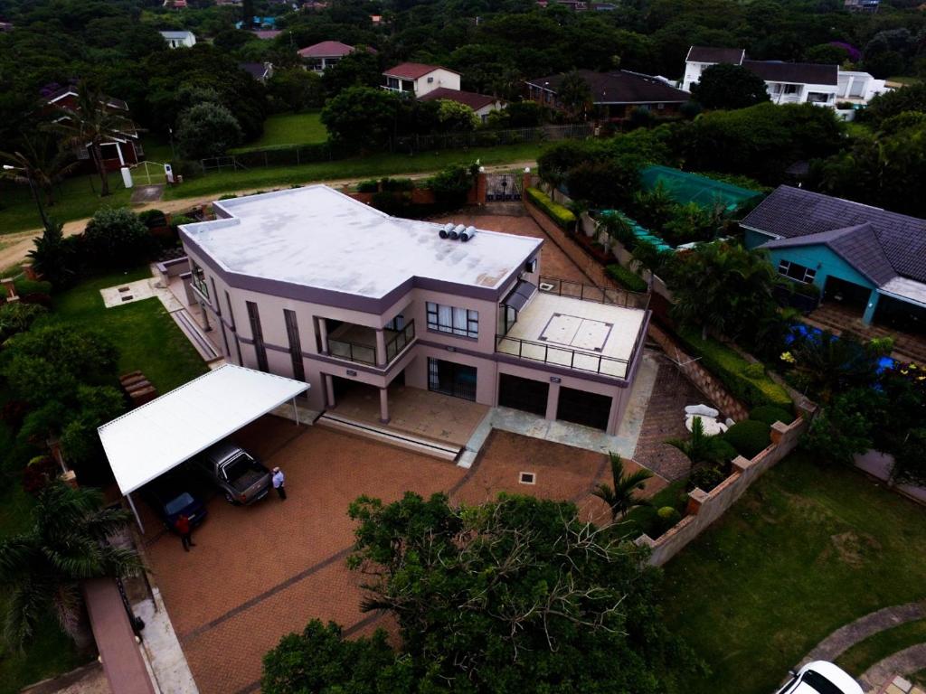 an aerial view of a large house with a roof at Tuscany By The Sea in Port Edward