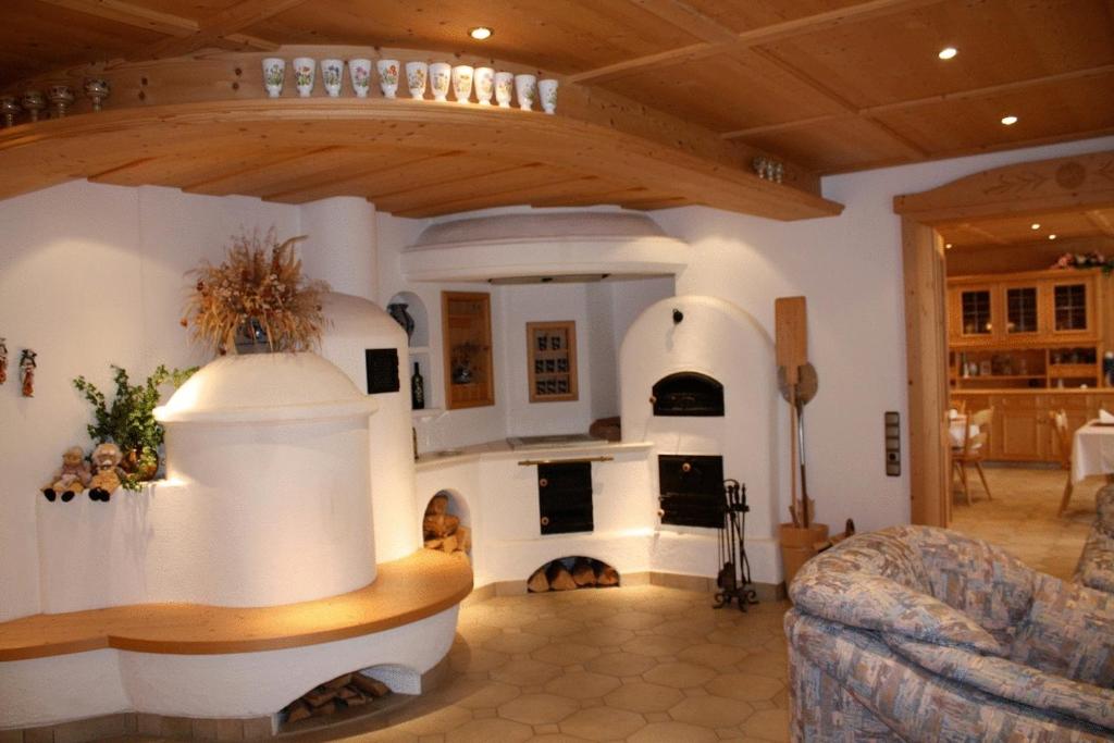 a large living room with a fireplace and a couch at Gästehaus Sonja in Durach