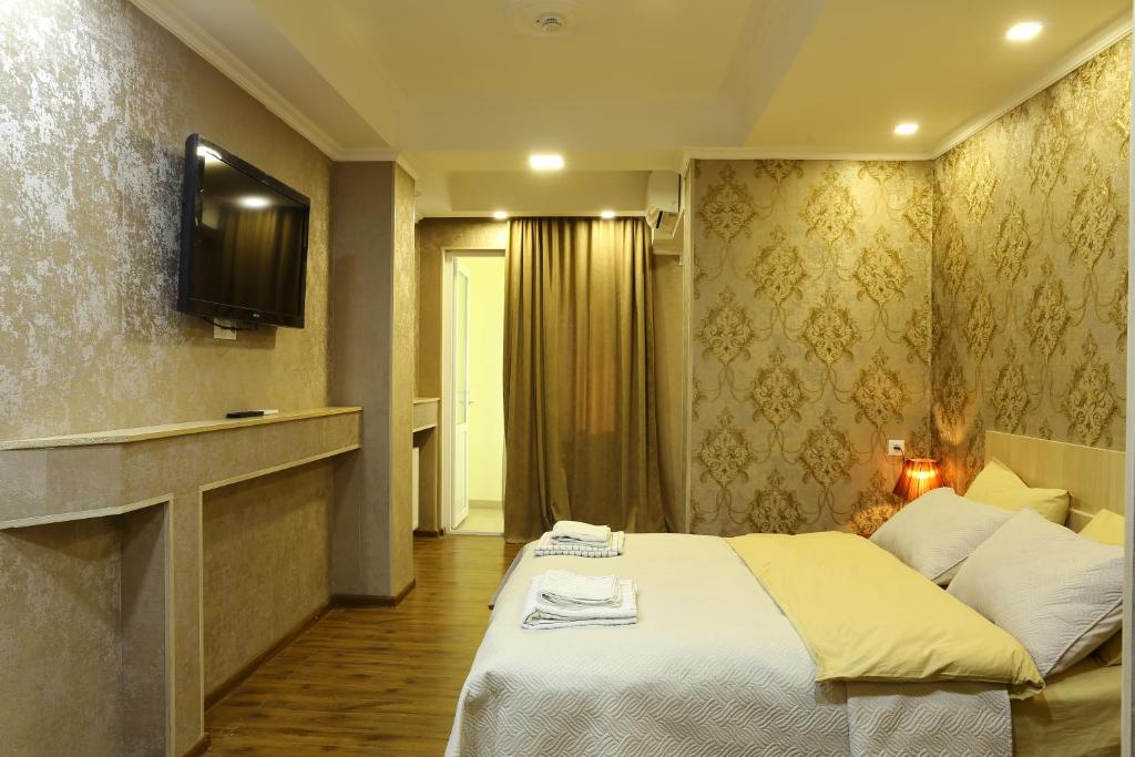 Postel nebo postele na pokoji v ubytování Dkd-bridge Hotel