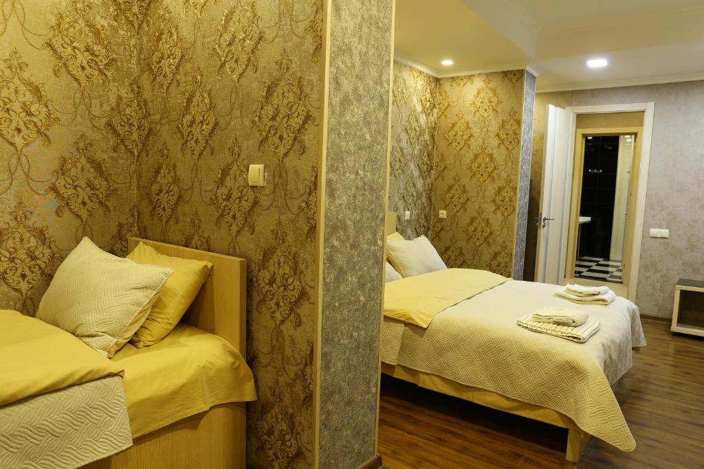 Postel nebo postele na pokoji v ubytování Dkd-bridge Hotel