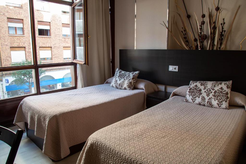 Postel nebo postele na pokoji v ubytování Alojamientos Rooms Catamarán