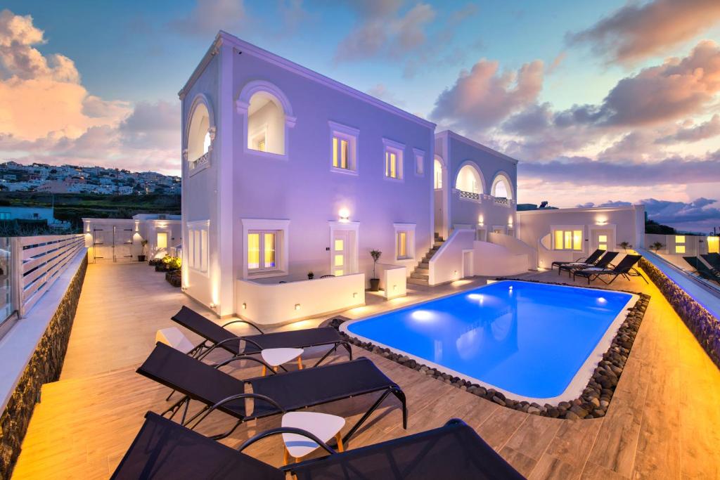 a villa with a large swimming pool on a deck at Abasa Suites in Fira