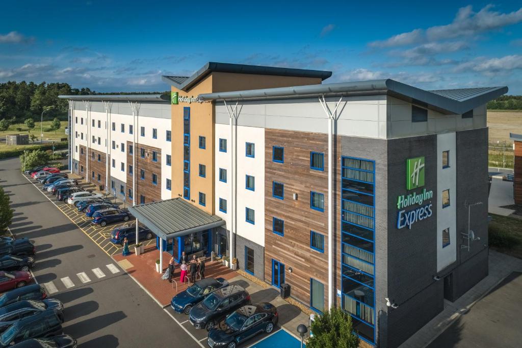 an aerial view of a hotel with a parking lot at Holiday Inn Express Kettering, an IHG Hotel in Kettering