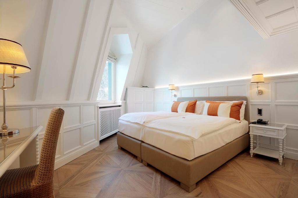 Postel nebo postele na pokoji v ubytování Grand Hôtel des Alpes