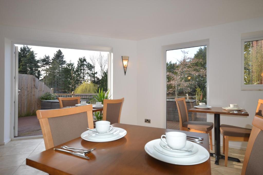 a dining room with a table and chairs at Lakeside Old Hunstanton in Hunstanton