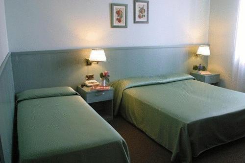 Postel nebo postele na pokoji v ubytování Albergo Della Corona