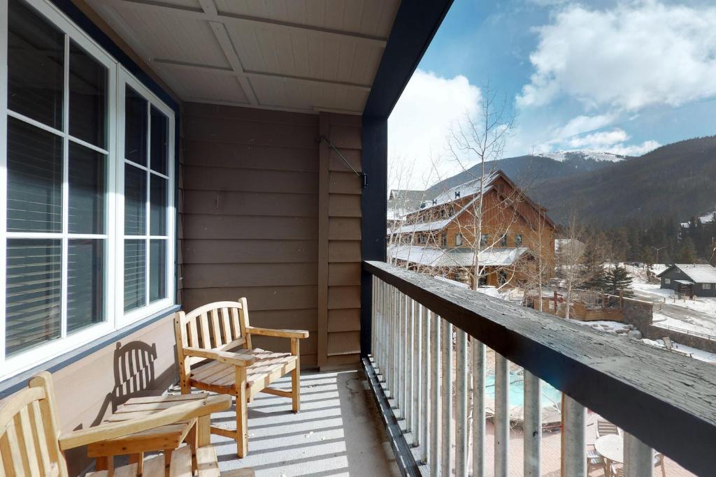 a porch with two chairs and a view of a mountain at The Dakota Outpost in Keystone