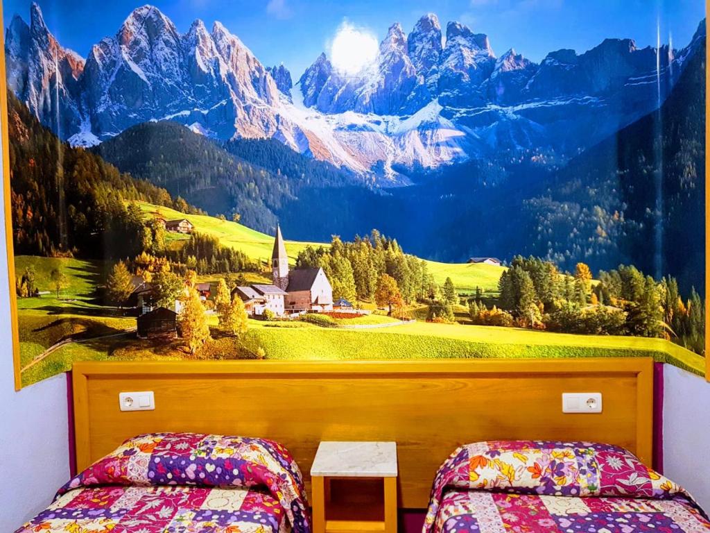 a bedroom with a mountain mural on the wall at ALBOR II in Gijón