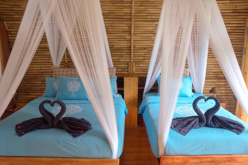 Postel nebo postele na pokoji v ubytování Lagoona Beach Bungalows - Eco Stay