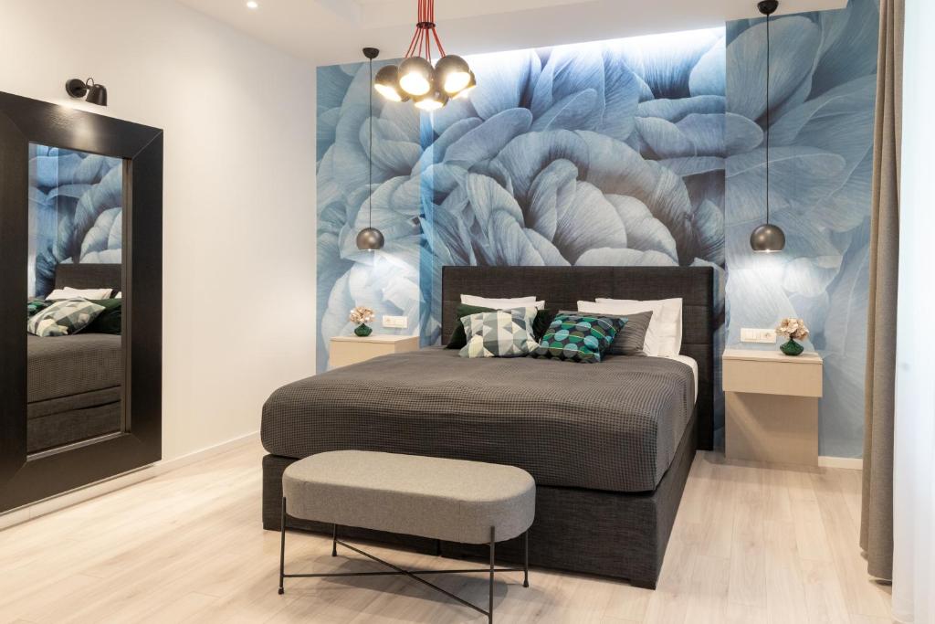 a bedroom with a bed and a wall mural at Sweet Dreams-Old Town in Split