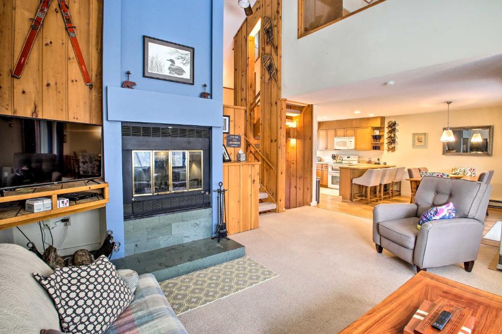 a living room with a couch and a fireplace at Loon Mountain Condo with Pool and Game Room Access! in Lincoln