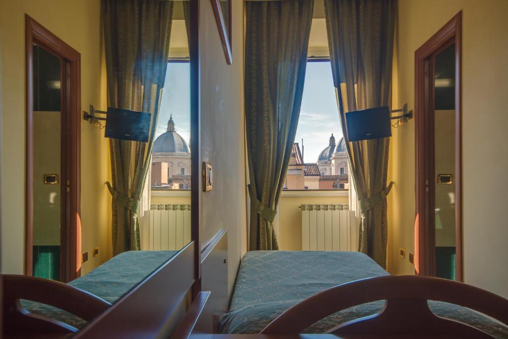 a room with two beds and a view of the city at Hotel Giorgina in Rome