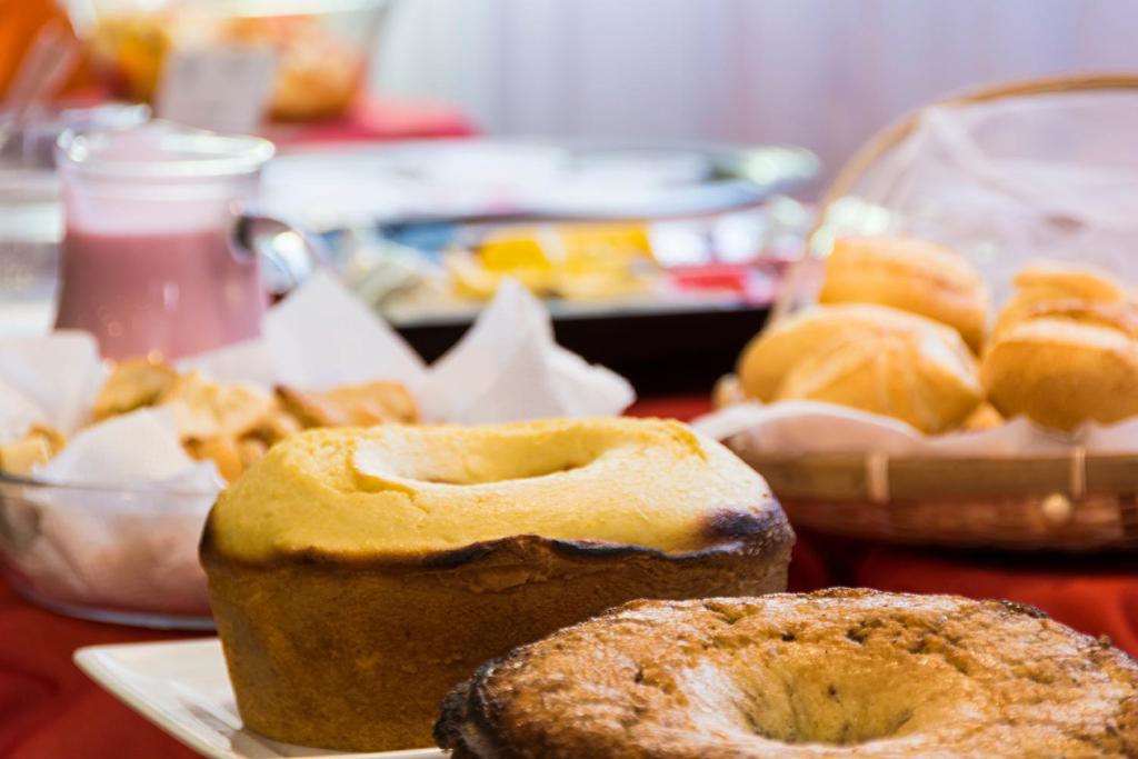 a table with a bunch of pastries on a table at Hotel Vila Rica Campinas in Campinas