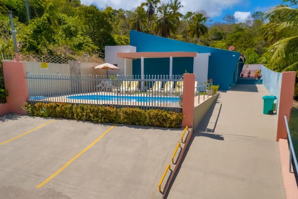 a house with a swimming pool in a parking lot at Flat Vila dos Milagres in São Miguel dos Milagres