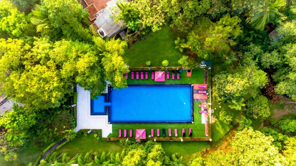 an overhead view of a swimming pool in a yard with trees at Heritage Hotel in Anuradhapura