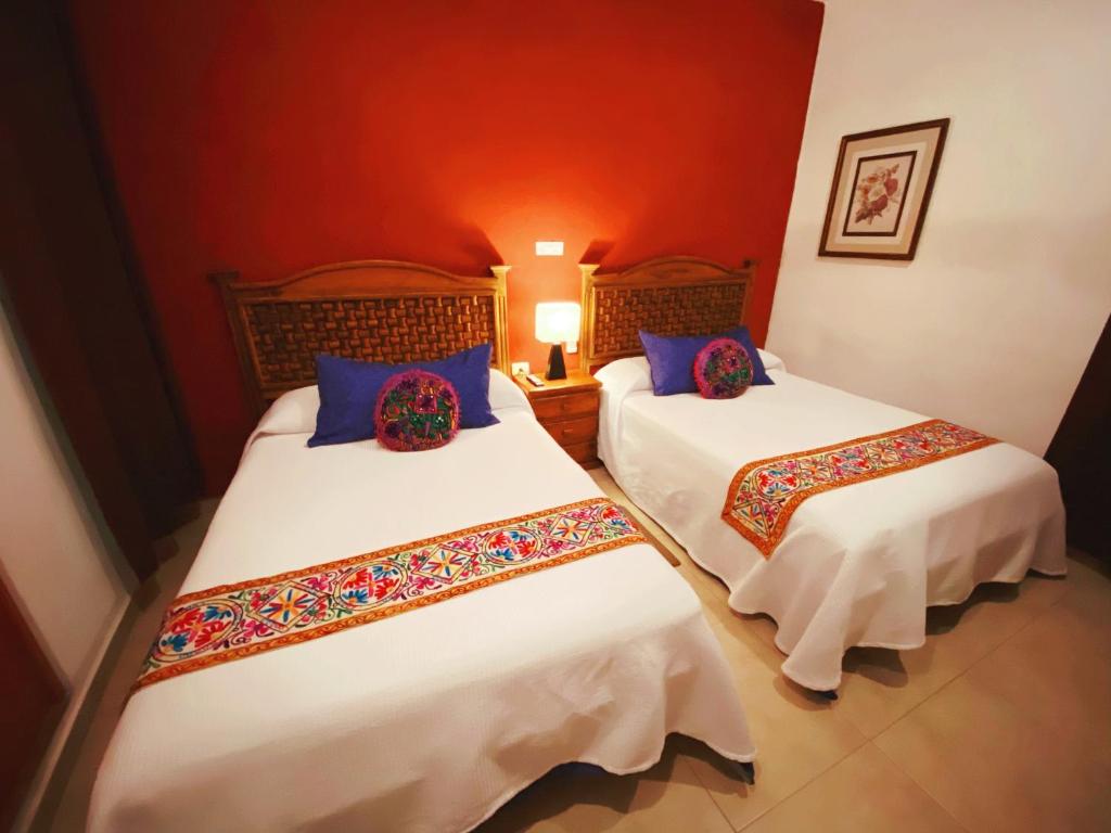 Postel nebo postele na pokoji v ubytování Hotel Real Colonial