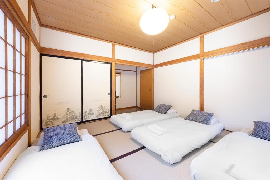Postel nebo postele na pokoji v ubytování Nozawa Peaks