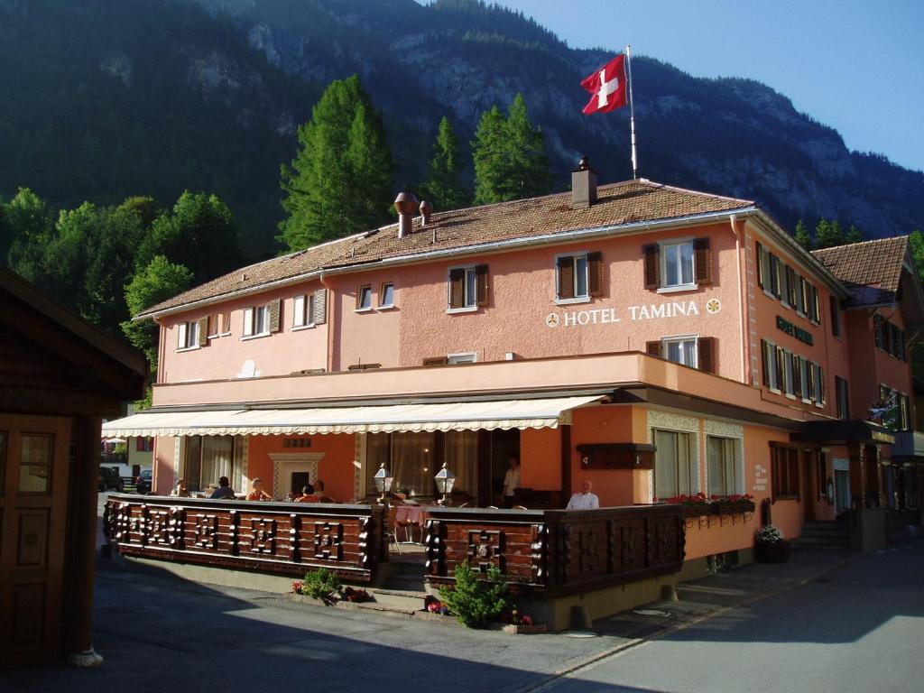 a building with a canadian flag on top of it at Tamina Hotel in Vättis