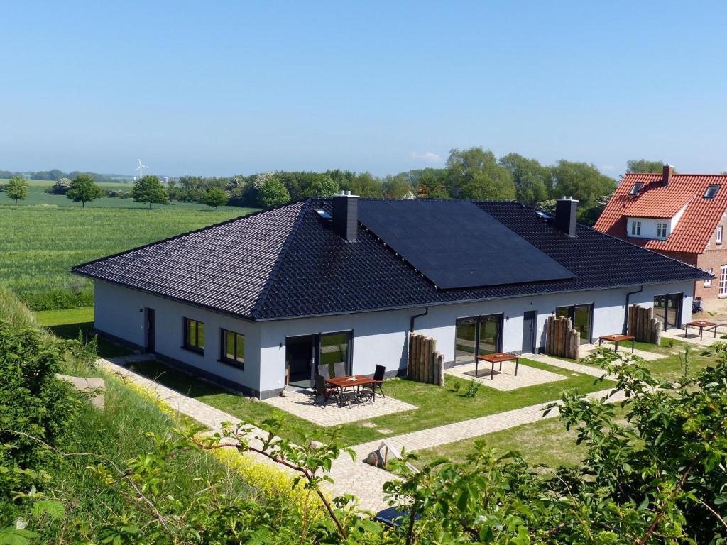 a house with solar panels on the roof at Haus Kranichfeld Wohnung S in Dranske