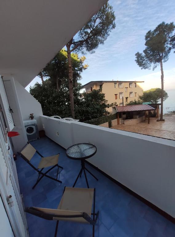 a balcony with chairs and a table and a view of the ocean at Appartamento Affaccio sul mare, Baia di Copanello in Copanello