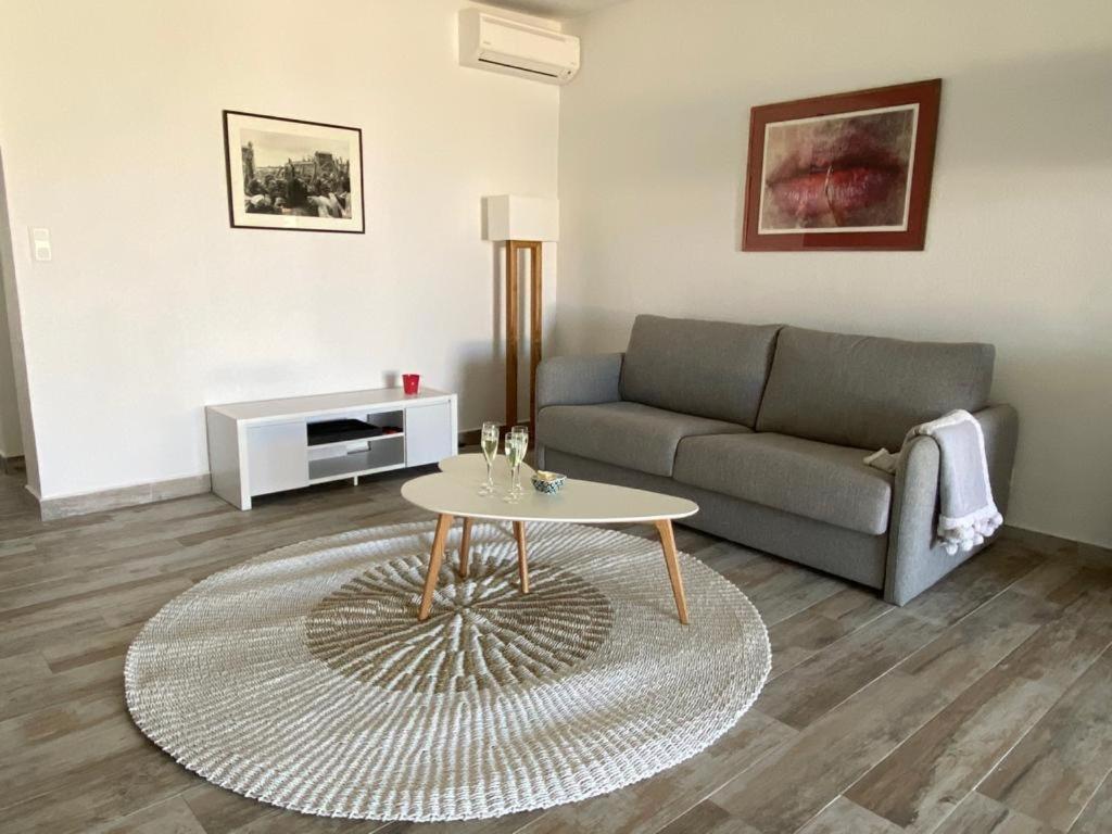 a living room with a couch and a table at La Bo-Aime in Orient Bay