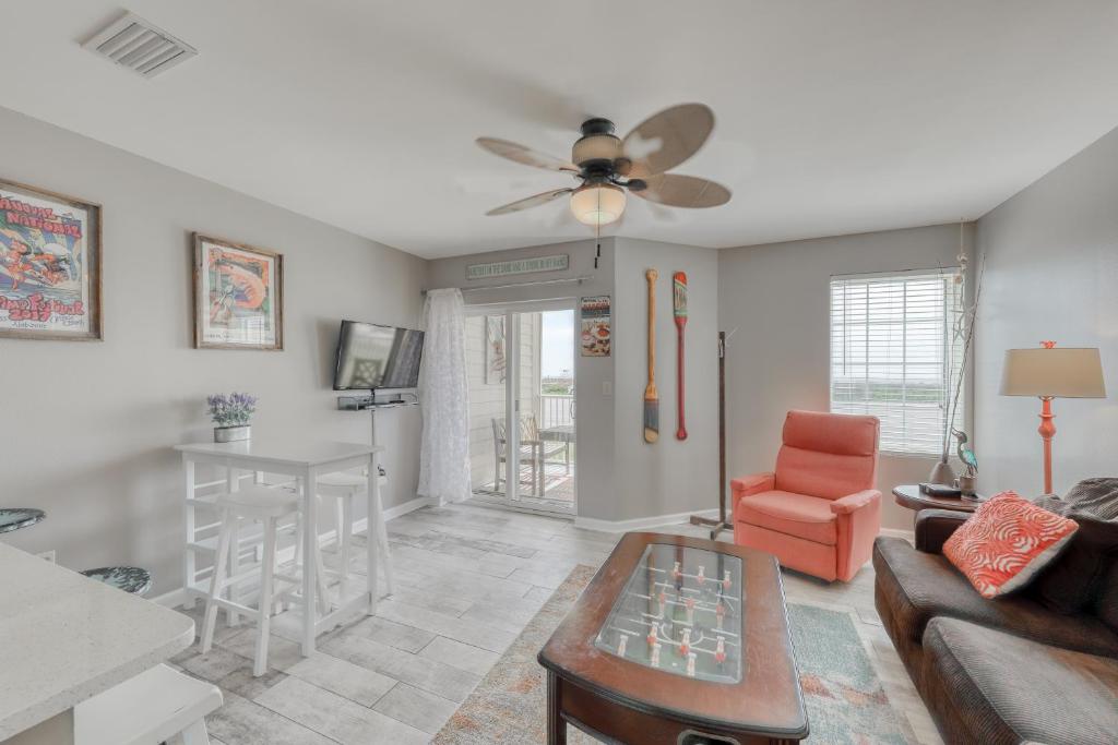 a living room with a couch and a ceiling fan at Grand Caribbean #103 in Orange Beach