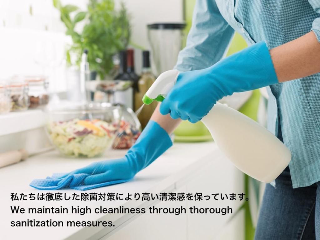 a person in a kitchen with a mortar and pestle at Sumida-ku - House / Vacation STAY 66502 in Tokyo