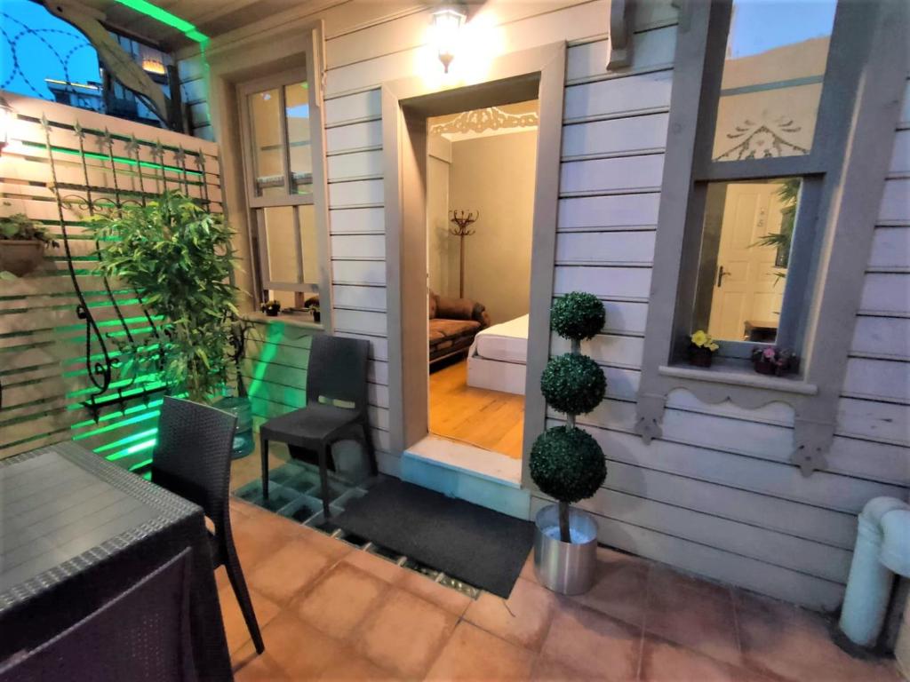 a house with a porch with a table and chairs at valide-maide hotel in Istanbul