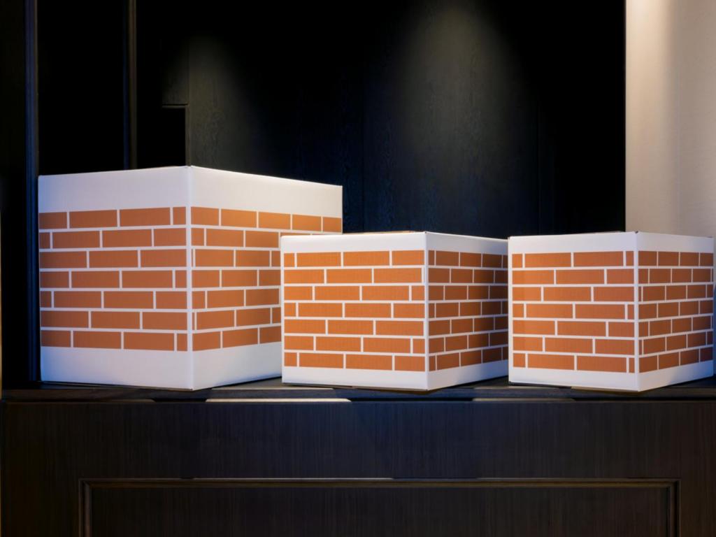 three stacks of bricks sitting on top of a table at LIBER HOTEL Osaka in Osaka