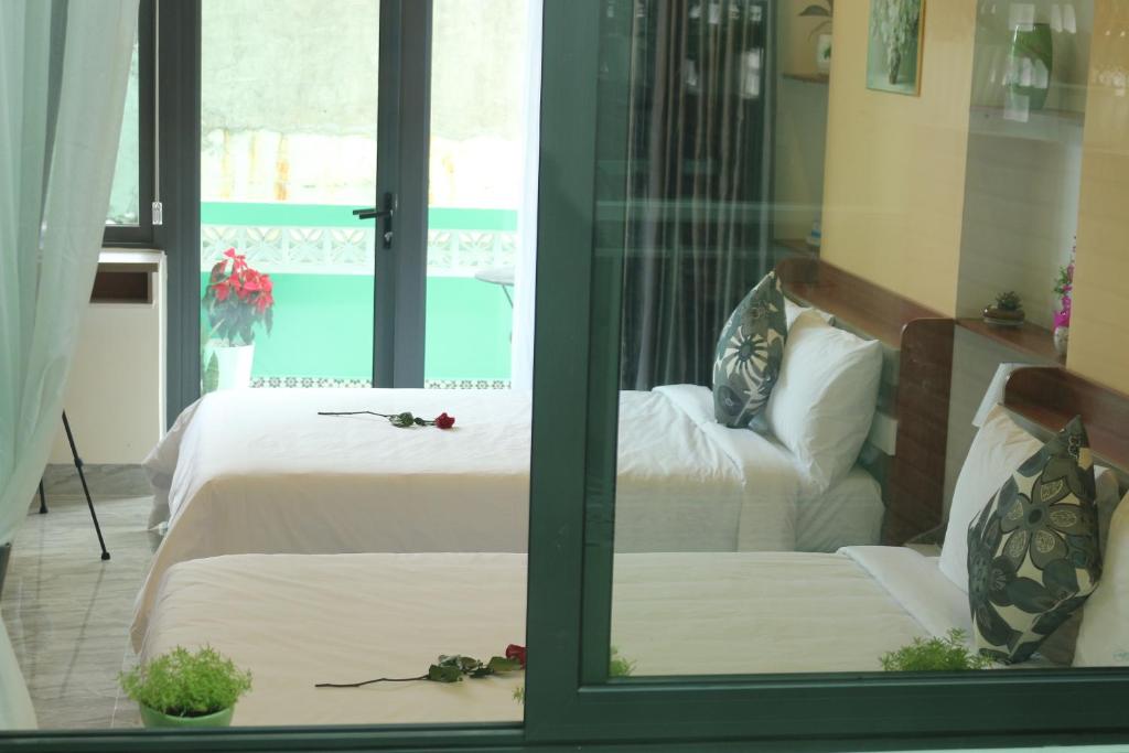 Giường trong phòng chung tại Lam Garden Boutique Homestay