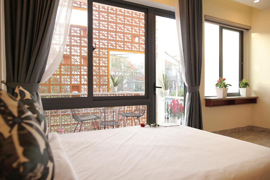 Giường trong phòng chung tại Lam Garden Boutique Homestay
