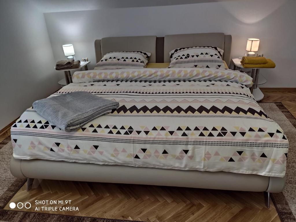 a bedroom with a large bed with two pillows at Kaya 2 in Đakovo