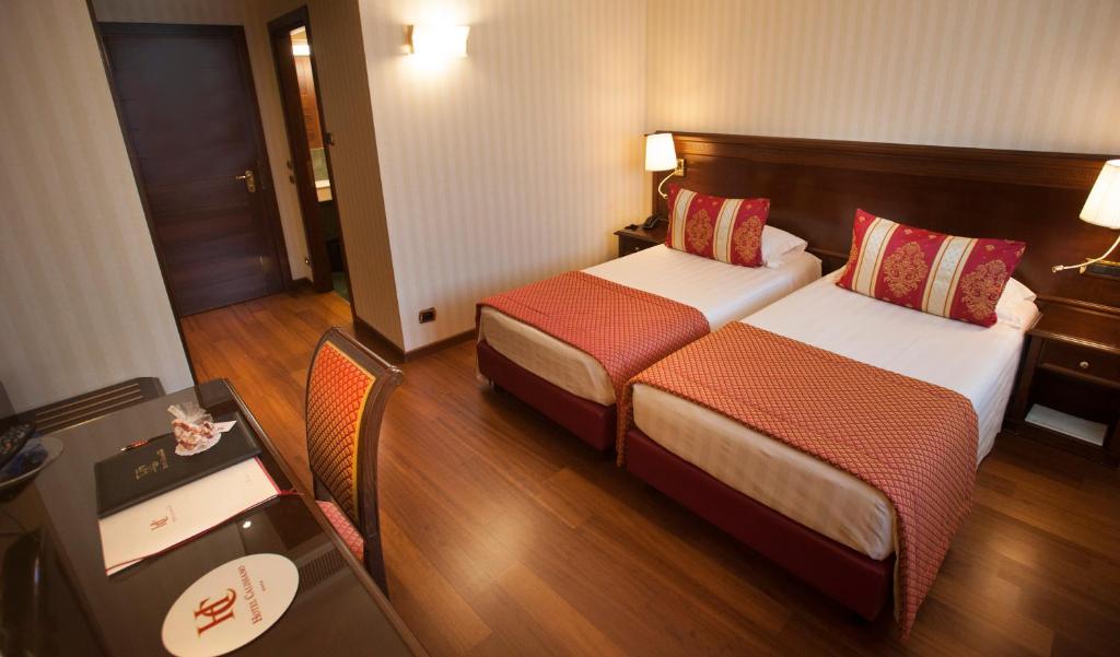 Postel nebo postele na pokoji v ubytování Hotel Calissano