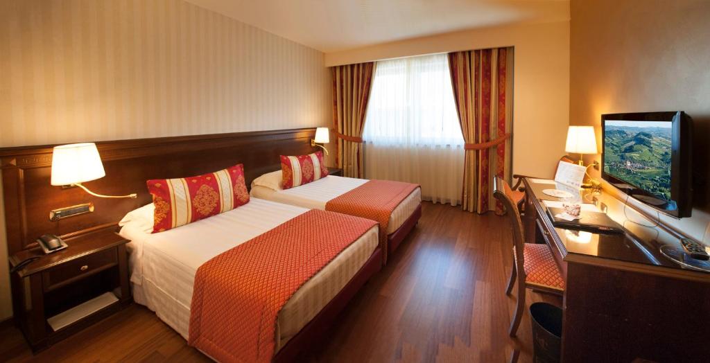 Postel nebo postele na pokoji v ubytování Hotel Calissano