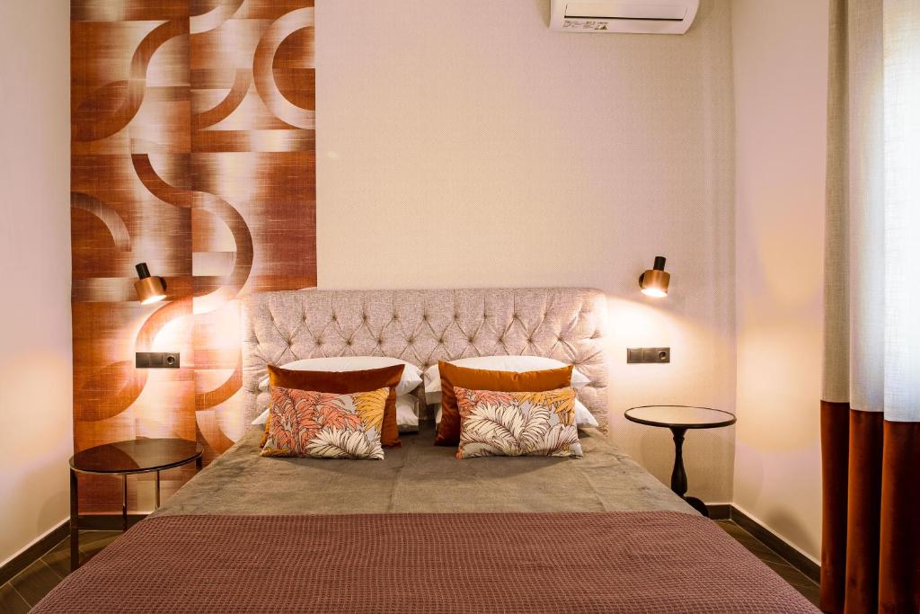 a bedroom with a large bed with two pillows at Living in Nafplio Luxury Apartments in Nafplio