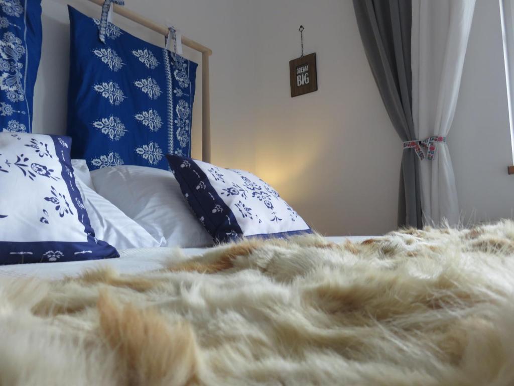 a bed with a furry blanket and pillows on it at MyMara , Apartmán Ivadella in Bešeňová