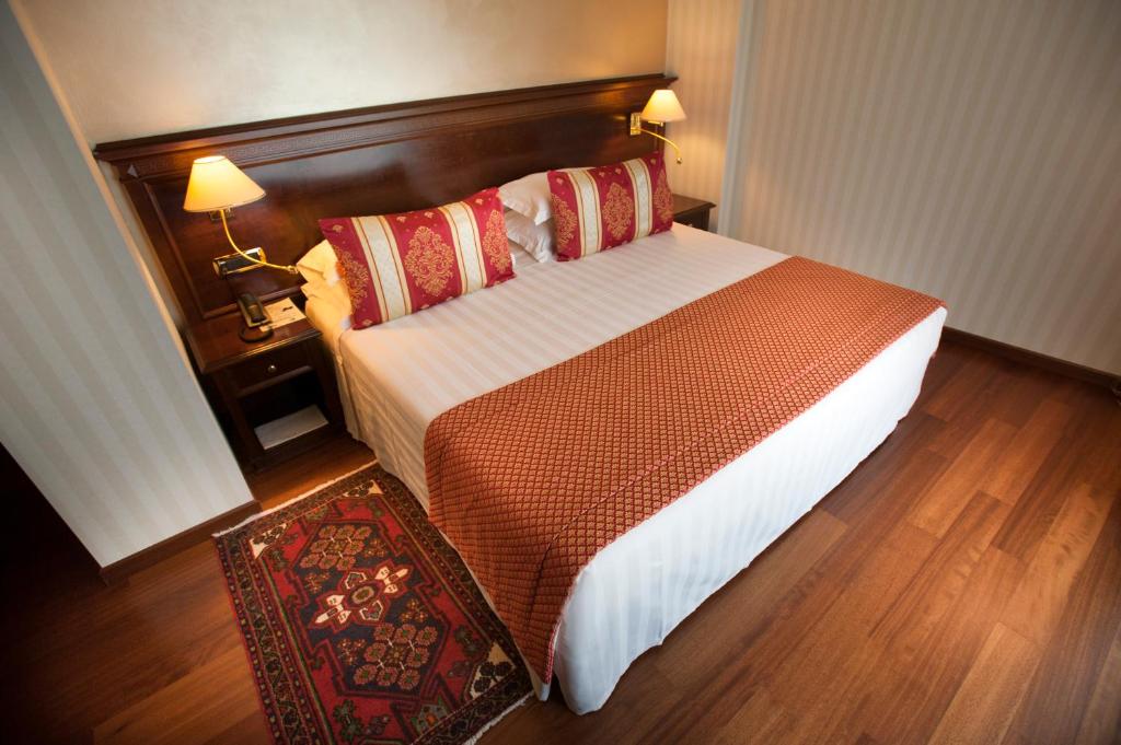 Postel nebo postele na pokoji v ubytování Hotel Calissano