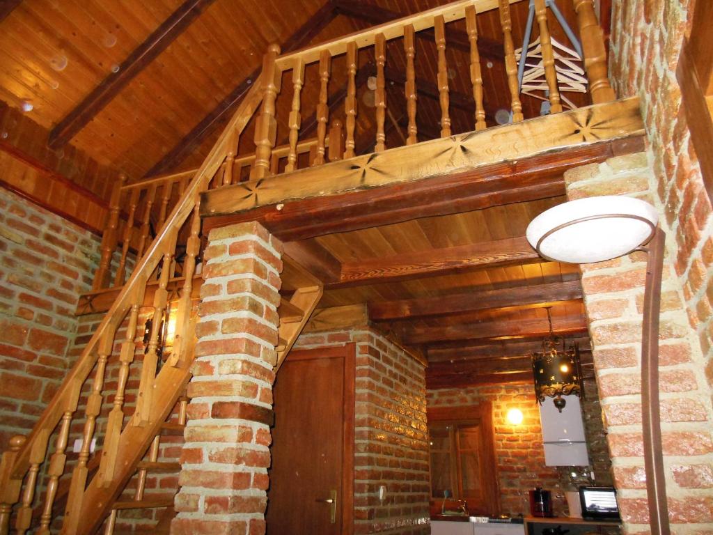 a wooden staircase in a room with a wooden ceiling at Cottage Plavi Lav Potok in Potok
