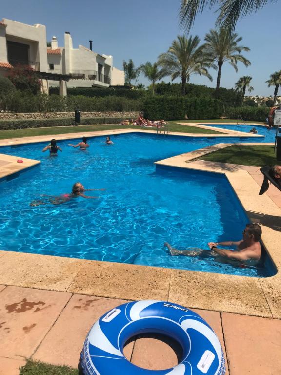 a group of people swimming in a swimming pool at Roda Golf & Beach Resort, Murcia in San Javier