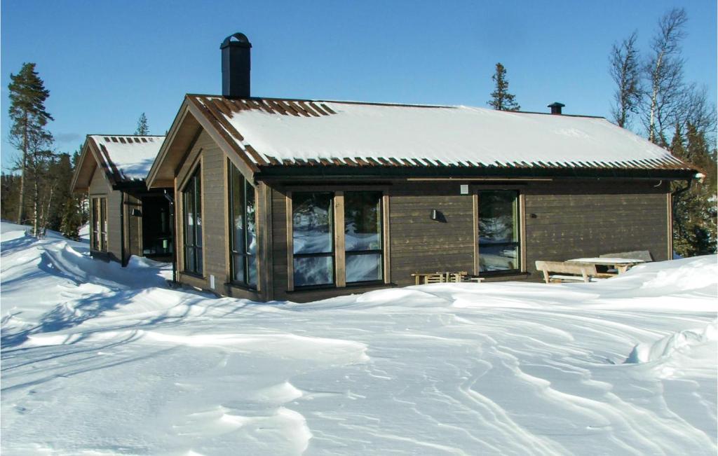 a house in the snow with a pile of snow at Stunning Home In Fl With 4 Bedrooms And Wifi in Flå