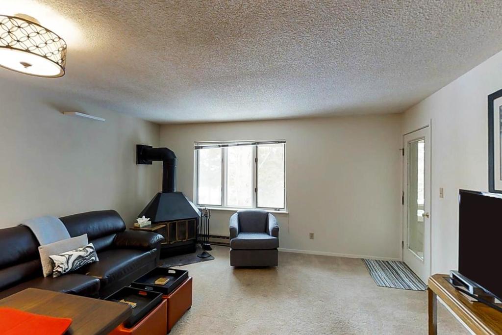 a living room with a couch and a fireplace at Grandview Condo in Breckenridge