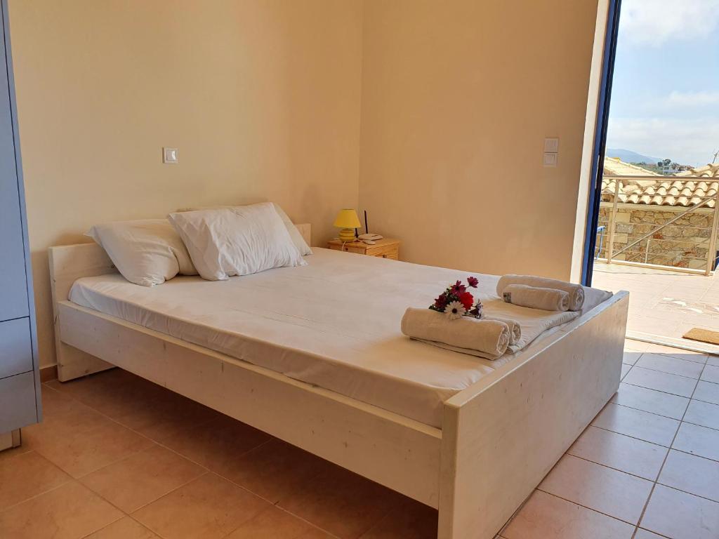 a large bed in a room with a large window at Stoupa Lefktro 3 in Stoupa