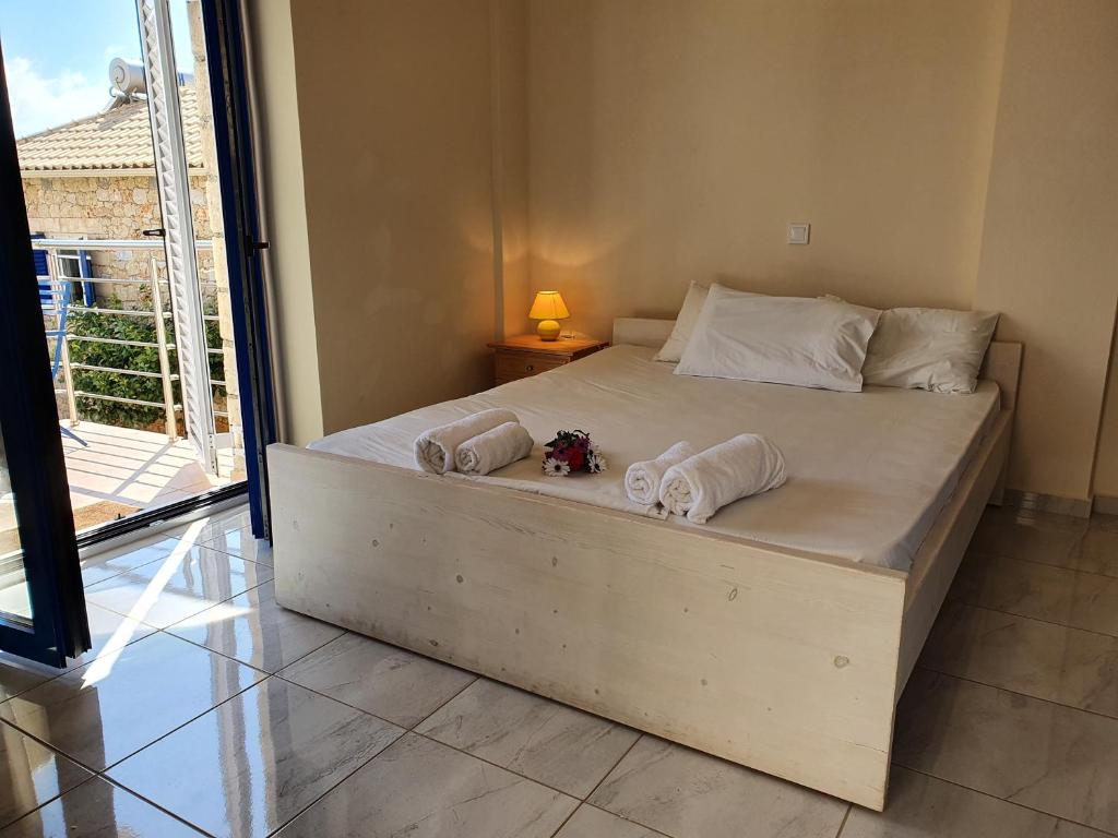 a bedroom with a large bed with towels on it at Stoupa Lefktro 4 in Stoupa