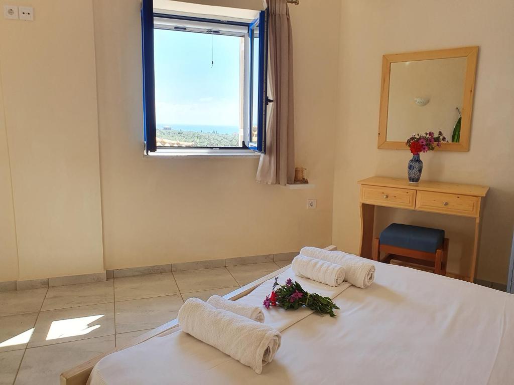 a bedroom with two beds with white sheets and a window at Stoupa Lefktro 5 in Stoupa