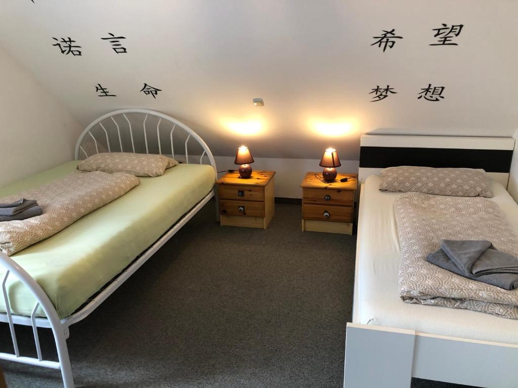 two beds in a room with writing on the wall at Ferienwohnung Aretsried 2 in Fischach