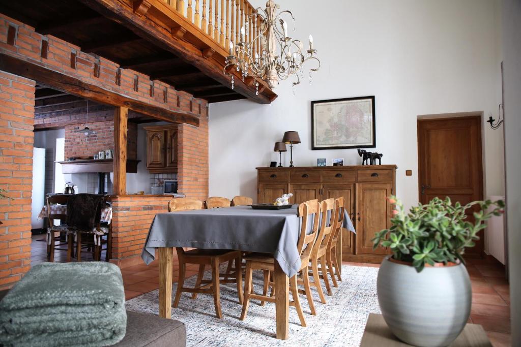 a kitchen and dining room with a table and chairs at La Croix Bala in Signy-le-Petit